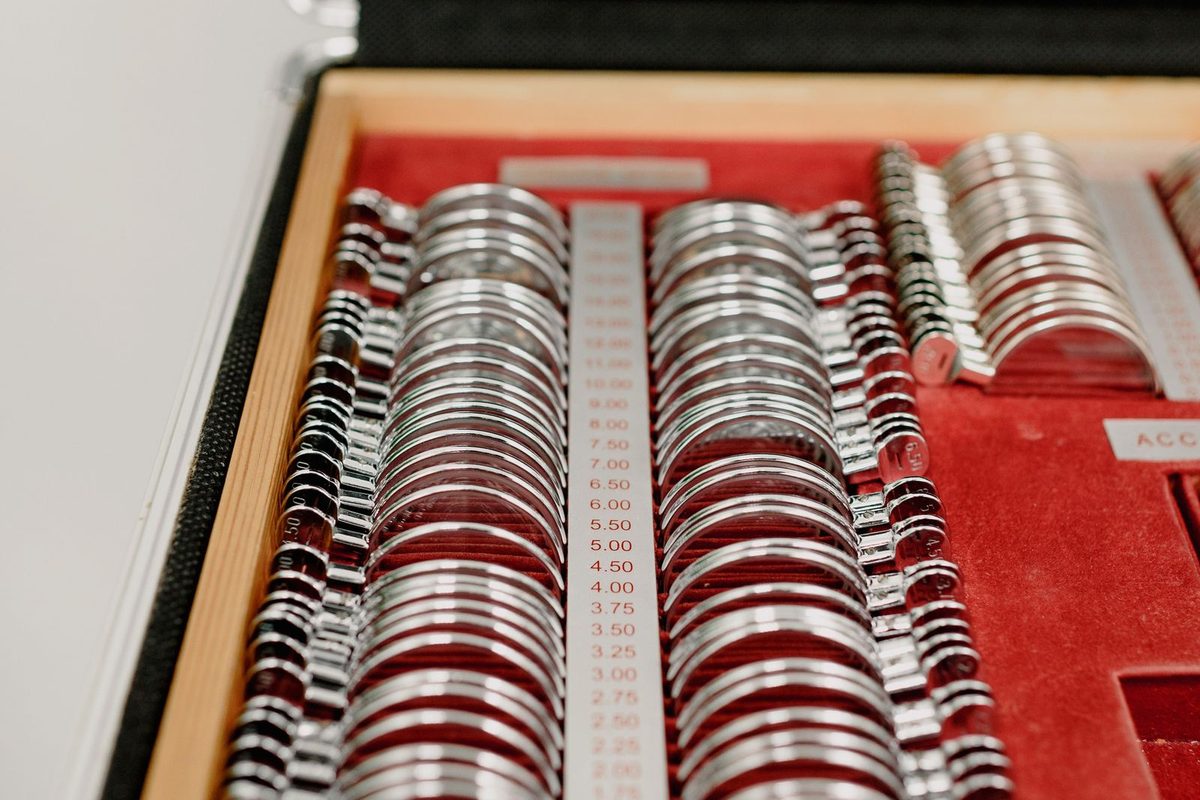 A trial lens set in its case, each lens marked with its power